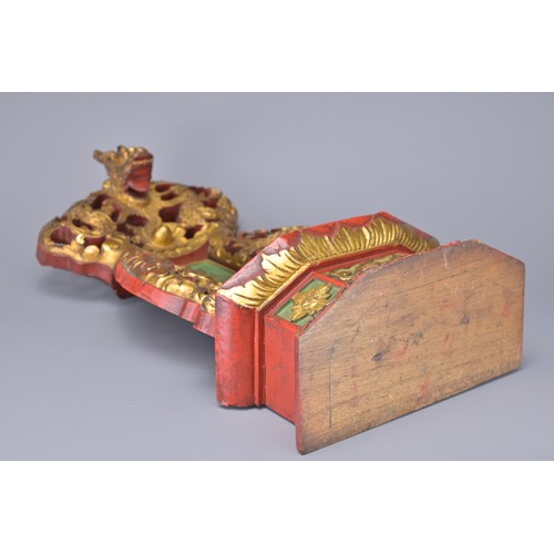 49 - A CHINESE GILT AND RED LACQUER SHRINE, 19/20TH CENTURY. With pierced decoration of dragons either si... 