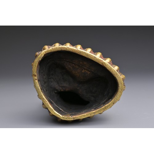 50 - A SINO-TIBETAN BRONZE BUDDHA Hollow cast seated on a lotus with three incised characters to rear abo... 