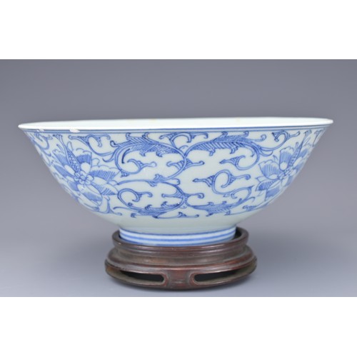 53 - A CHINESE BLUE AND WHITE PORCELAIN BOWL, 19TH CENTURY. Decorated to the exterior with lotus scrolls.... 