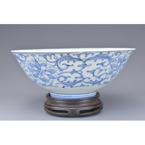 53 - A CHINESE BLUE AND WHITE PORCELAIN BOWL, 19TH CENTURY. Decorated to the exterior with lotus scrolls.... 