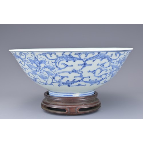 53 - A CHINESE BLUE AND WHITE PORCELAIN BOWL, 19TH CENTURY. Decorated to the exterior with lotus scrolls.... 