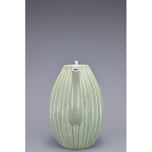 54 - A KOREAN MELON-SHAPED PORCELAIN EWER. With ribbed bamboo design. 18cm height.