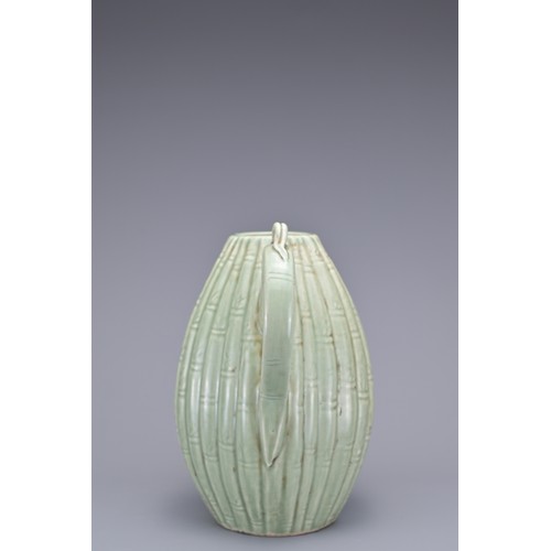 54 - A KOREAN MELON-SHAPED PORCELAIN EWER. With ribbed bamboo design. 18cm height.