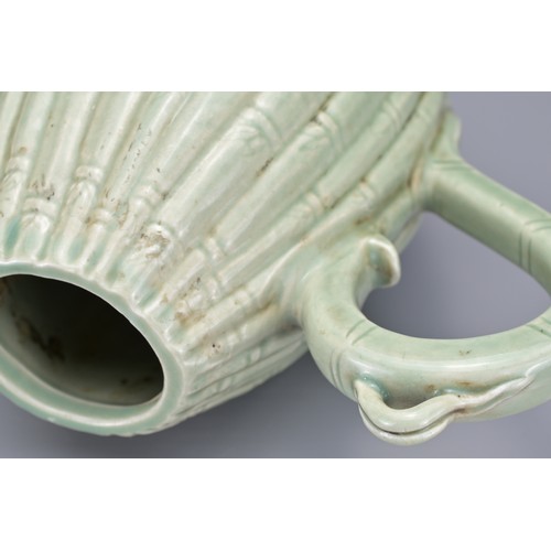 54 - A KOREAN MELON-SHAPED PORCELAIN EWER. With ribbed bamboo design. 18cm height.