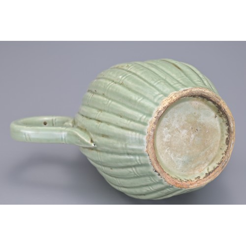 54 - A KOREAN MELON-SHAPED PORCELAIN EWER. With ribbed bamboo design. 18cm height.