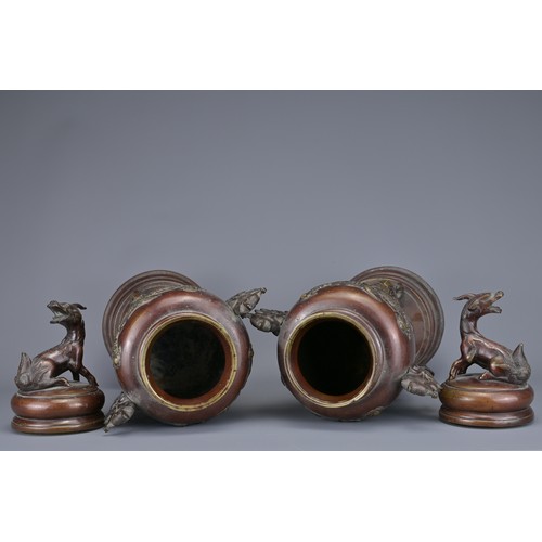 62 - A PAIR OF JAPANESE BRONZE LIDDED URNS. Each with ornate legs and dragon form handles with raised flo... 