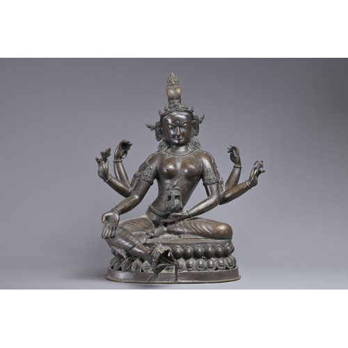 63 - A LARGE INDIAN BRONZE FIGURE OF VASUDHARA, 19/20TH CENTURY. The Goddess sat on a double lotus pedest... 