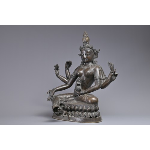 63 - A LARGE INDIAN BRONZE FIGURE OF VASUDHARA, 19/20TH CENTURY. The Goddess sat on a double lotus pedest... 