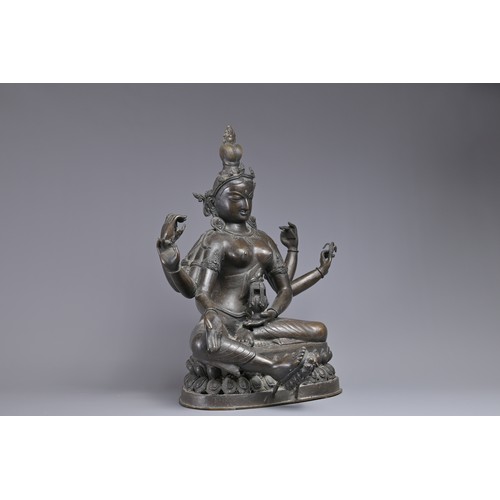 63 - A LARGE INDIAN BRONZE FIGURE OF VASUDHARA, 19/20TH CENTURY. The Goddess sat on a double lotus pedest... 