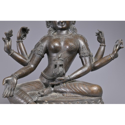 63 - A LARGE INDIAN BRONZE FIGURE OF VASUDHARA, 19/20TH CENTURY. The Goddess sat on a double lotus pedest... 