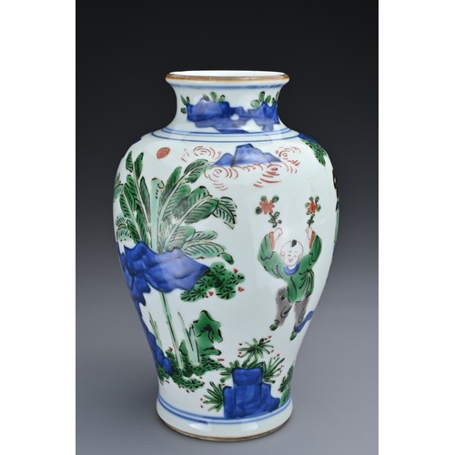 72 - A CHINESE WUCAI PORCELAIN JAR. Of baluster form decorated with ladies and children playing in landsc... 