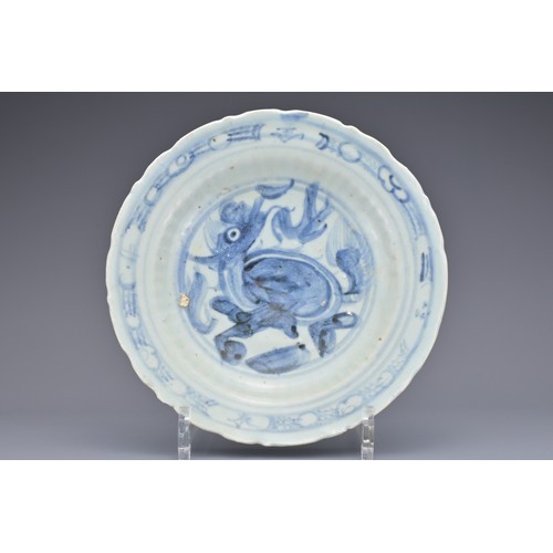 74 - A CHINESE BLUE AND WHITE PORCELAIN DISH, MING DYNASTY. Barbed rim and ribbed body decorated with qil... 