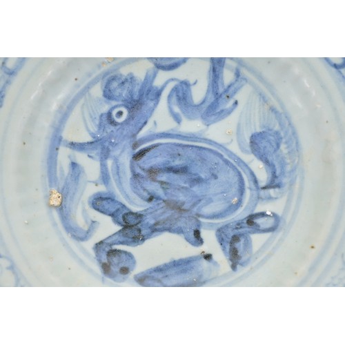 74 - A CHINESE BLUE AND WHITE PORCELAIN DISH, MING DYNASTY. Barbed rim and ribbed body decorated with qil... 