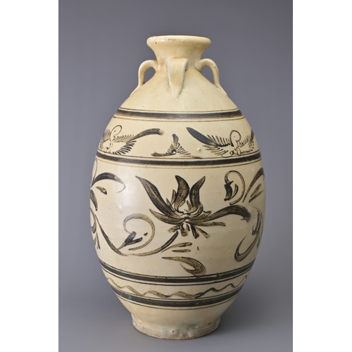 99 - A TALL CHINESE CIZHOU STONEWARE JAR. With four loop handles at the shoulder and decorated in iron-br... 