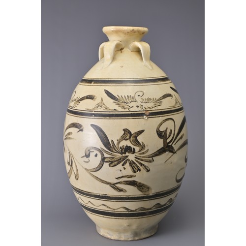 99 - A TALL CHINESE CIZHOU STONEWARE JAR. With four loop handles at the shoulder and decorated in iron-br... 