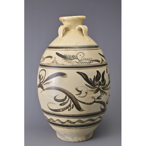 99 - A TALL CHINESE CIZHOU STONEWARE JAR. With four loop handles at the shoulder and decorated in iron-br... 