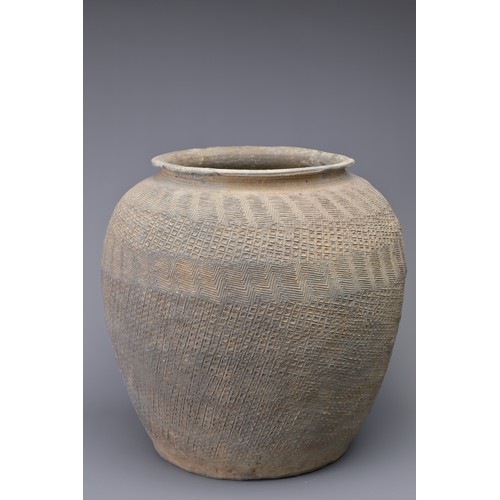 100 - A LARGE CHINESE WARRING STATES IMPRESSED POTTERY JAR. Relatively highly-fired, the whole outer surfa... 