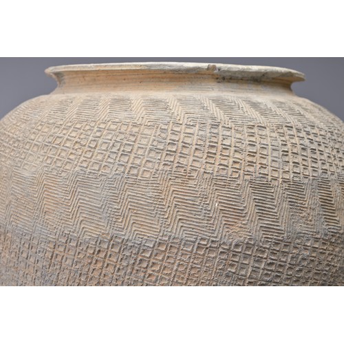 100 - A LARGE CHINESE WARRING STATES IMPRESSED POTTERY JAR. Relatively highly-fired, the whole outer surfa... 