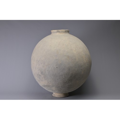 101 - A GIANT CHINESE POTTERY COCOON JAR – WARRING STATES. Heavily-potted, the surface decorated with repe... 