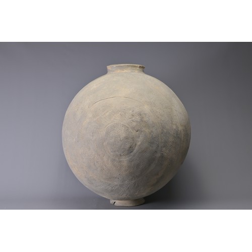 101 - A GIANT CHINESE POTTERY COCOON JAR – WARRING STATES. Heavily-potted, the surface decorated with repe... 