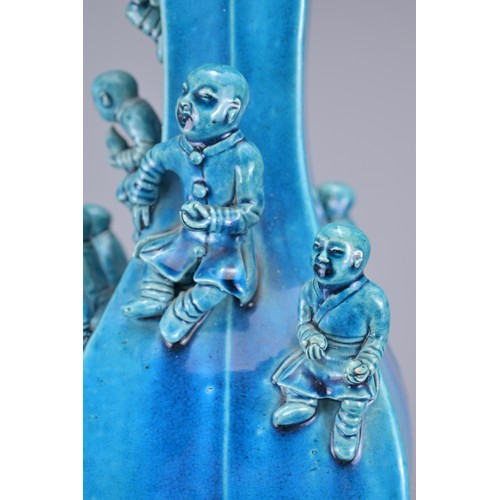 77 - A CHINESE TURQUOISE GLAZED PORCELAIN 'BOYS' VASE, 19TH CENTURY. The square from vase decorated with ... 