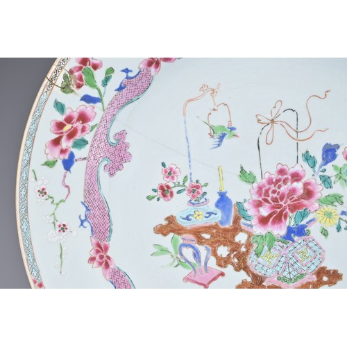 83 - A LARGE CHINESE FAMILLE ROSE EXPORT PORCELAIN DISH, 18TH CENTURY. With decorative scene of ornamenta... 