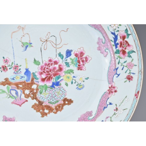 83 - A LARGE CHINESE FAMILLE ROSE EXPORT PORCELAIN DISH, 18TH CENTURY. With decorative scene of ornamenta... 