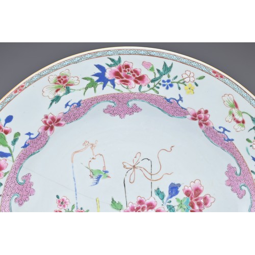 83 - A LARGE CHINESE FAMILLE ROSE EXPORT PORCELAIN DISH, 18TH CENTURY. With decorative scene of ornamenta... 