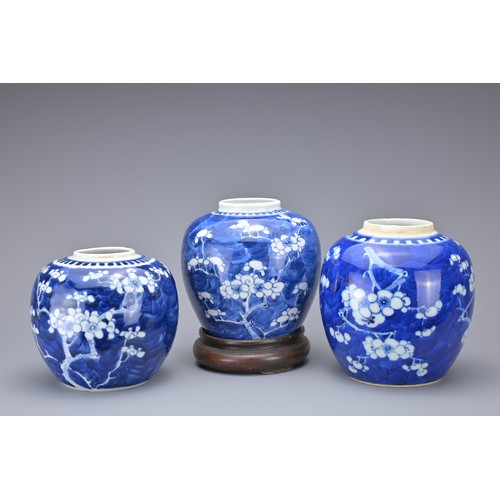 87 - THREE CHINESE BLUE AND WHITE PORCELAIN GINGER JARS, 19/20TH CENTURY. Of graduating sizes with prunus... 