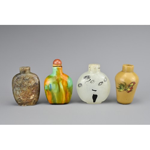 1 - FOUR CHINESE SNUFF BOTTLES. Comprising a polychrome glazed ceramic bottle with carnelian stopper; a ... 