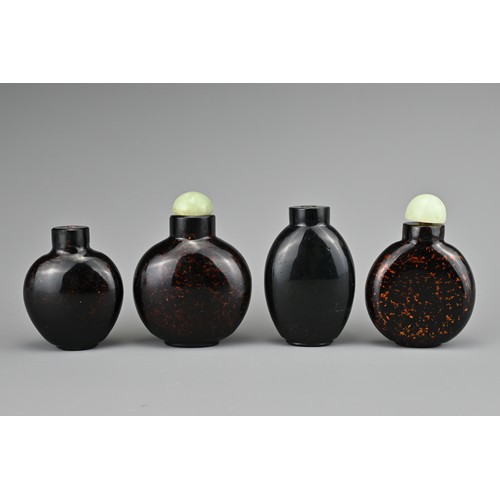 10 - FOUR CHINESE GLASS SNUFF BOTTLES. To include three aventurine glass bottles, with gold / bronze colo... 