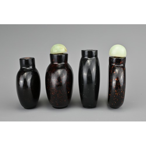 10 - FOUR CHINESE GLASS SNUFF BOTTLES. To include three aventurine glass bottles, with gold / bronze colo... 