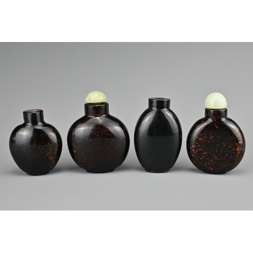 10 - FOUR CHINESE GLASS SNUFF BOTTLES. To include three aventurine glass bottles, with gold / bronze colo... 