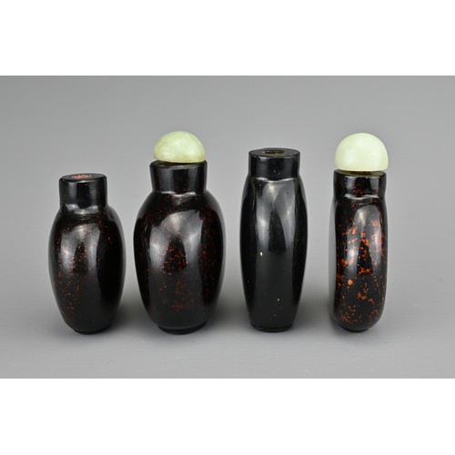 10 - FOUR CHINESE GLASS SNUFF BOTTLES. To include three aventurine glass bottles, with gold / bronze colo... 