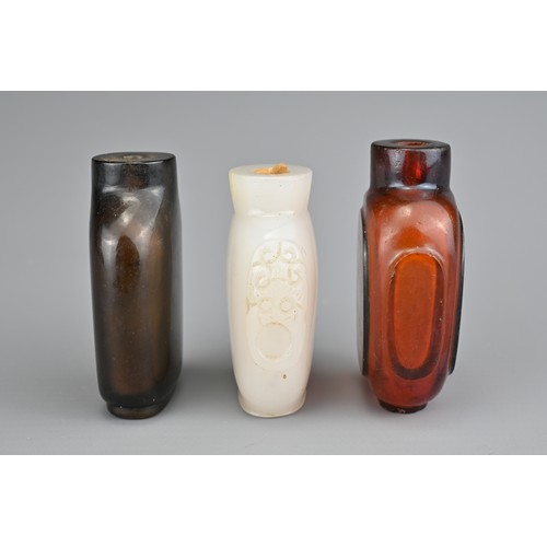 12 - THREE CHINESE COLOURED GLASS SNUFF BOTTLES. Each of various forms. 5-5.5cm tall. (3)

Provenance: Pr... 