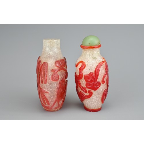 13 - TWO CHINESE GLASS SNUFF BOTTLES. To include a red-overlay glass bottle with horse under a tree. Toge... 