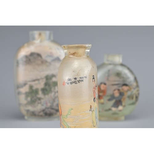 17 - THREE CHINESE INSIDE-PAINTED GLASS SNUFF BOTTLES. Depicting various figures and landscape scenes. 6-... 