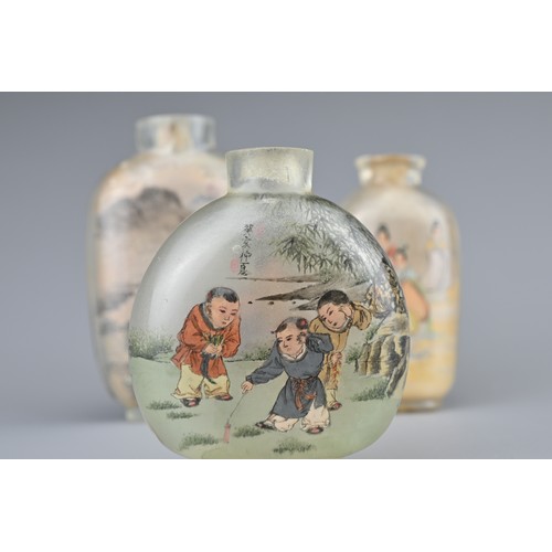 17 - THREE CHINESE INSIDE-PAINTED GLASS SNUFF BOTTLES. Depicting various figures and landscape scenes. 6-... 