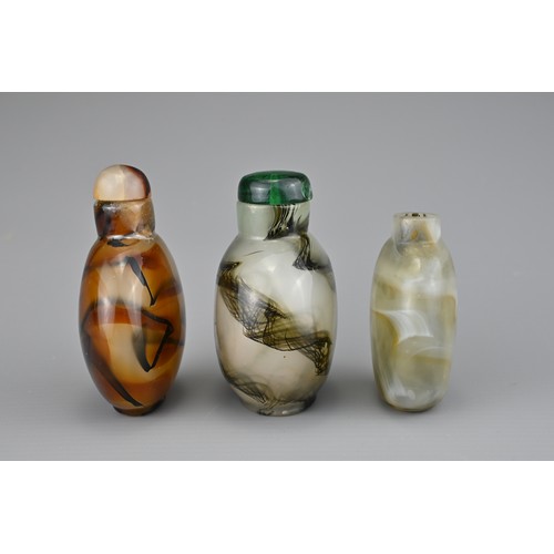 18 - THREE CHINESE GLASS SNUFF BOTTLES. Coloured glass imitation agate with splashes of black. Two with g... 