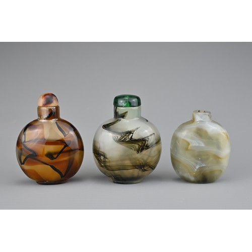 18 - THREE CHINESE GLASS SNUFF BOTTLES. Coloured glass imitation agate with splashes of black. Two with g... 