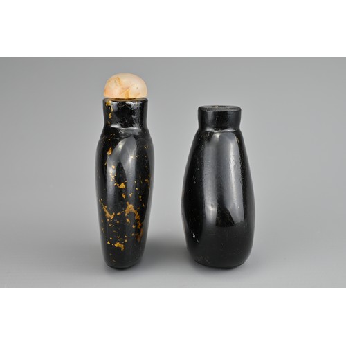 19 - TWO CHINESE GLASS SNUFF BOTTLES. To include an aventurine glass bottle with gold flecks and stone st... 