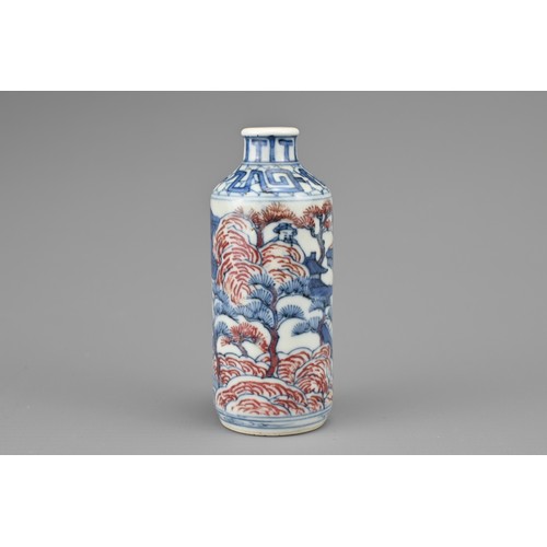 26 - A CHINESE UNDERGLAZE BLUE AND COPPER RED PORCELAIN SNUFF BOTTLE, QING DYNASTY. Of cylindrical form d... 