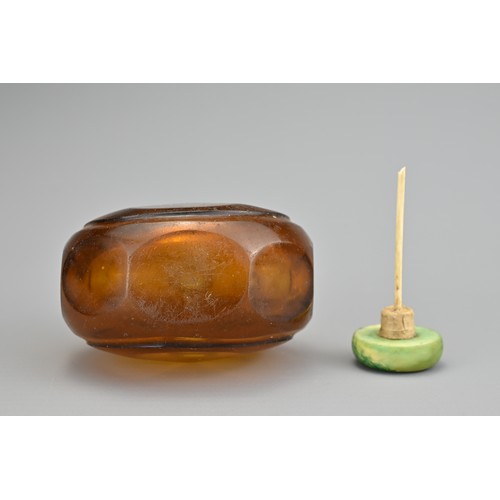 30 - AN AMBER FACETED GLASS SNUFF BOTTLE, QING DYNASTY. The amber coloured transparent glass in octagonal... 