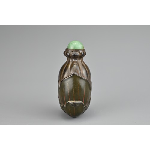 36 - AN UNUSUAL CHINESE LACQUER 'FRUIT' SNUFF BOTTLE, QING DYNASTY. Carved and painted lacquer with green... 