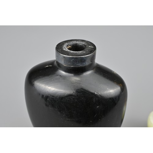 38 - AN UNUSUAL CHINESE BLACK LACQUERED SNUFF BOTTLE, QING DYNASTY. Undecorated with raised seal mark to ... 