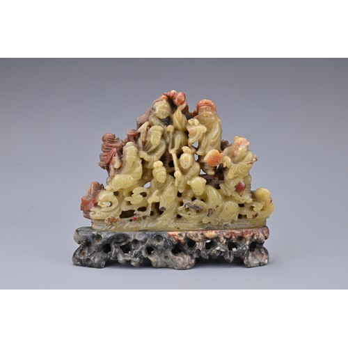 51 - A CHINESE SOAPSTONE CARVING OF EIGHT IMMORTALS, QING DYNASTY. Well-carved with figures on rock form ... 