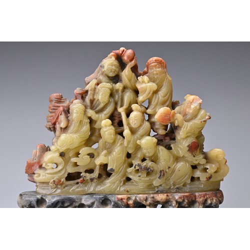 51 - A CHINESE SOAPSTONE CARVING OF EIGHT IMMORTALS, QING DYNASTY. Well-carved with figures on rock form ... 