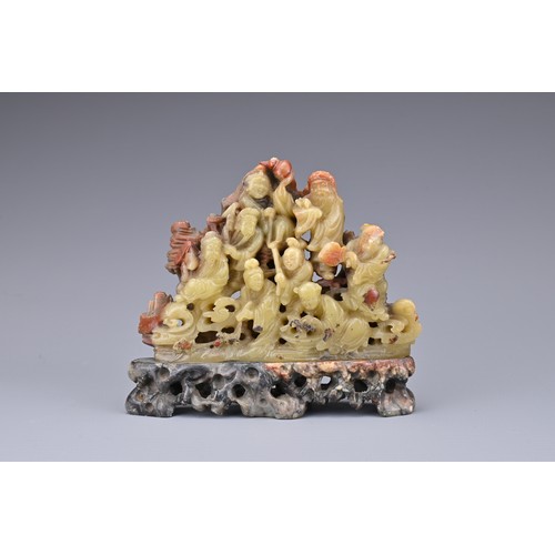 51 - A CHINESE SOAPSTONE CARVING OF EIGHT IMMORTALS, QING DYNASTY. Well-carved with figures on rock form ... 