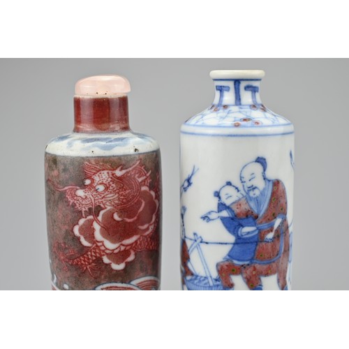 45 - TWO CHINESE UNDERGLAZE BLUE AND COPPER RED PORCELAIN SNUFF BOTTLES, QING DYNASTY. Both of cylindrica... 