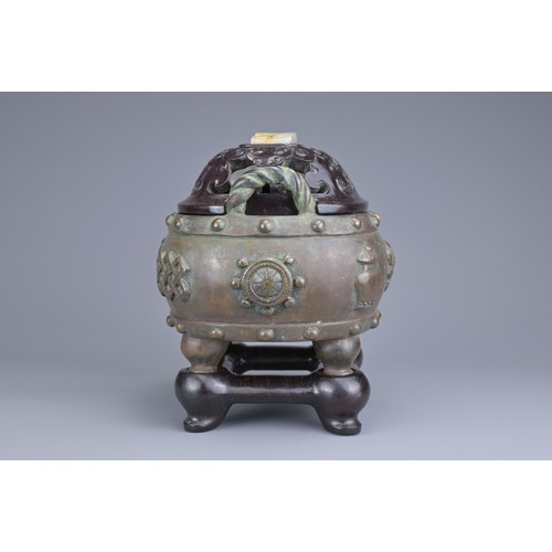 59 - A CHINESE BRONZE BAJIXIANG CENSER AND COVER. Of drum shape with raised rope twist handles on four le... 